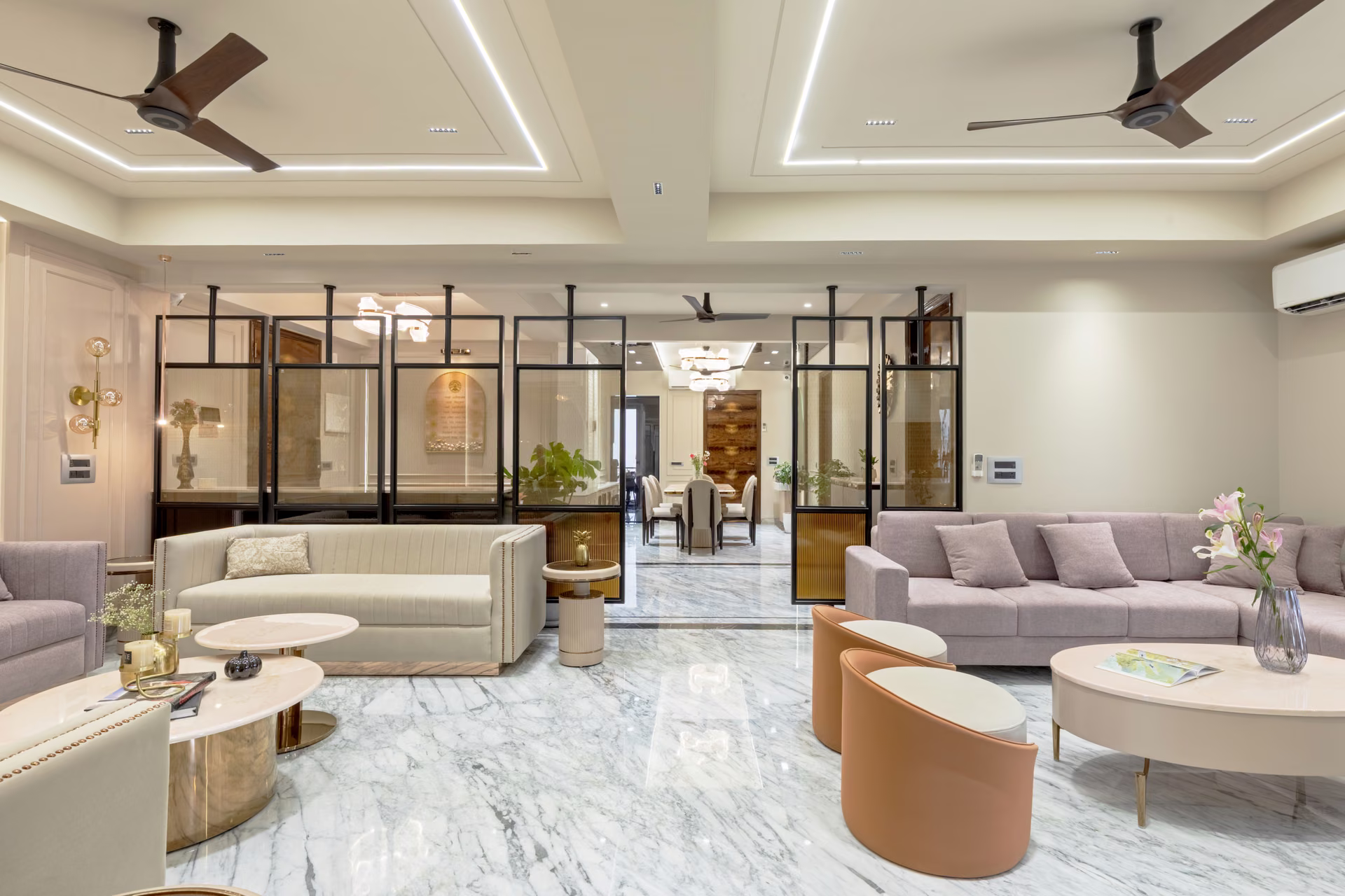 Luxury residential living room with marble flooring and glass partitions, designed and built by Forklyft Studio
